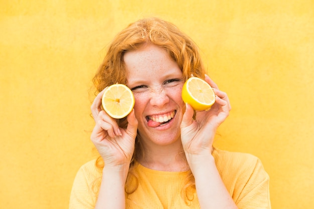 Close-up happy woman with lemons
