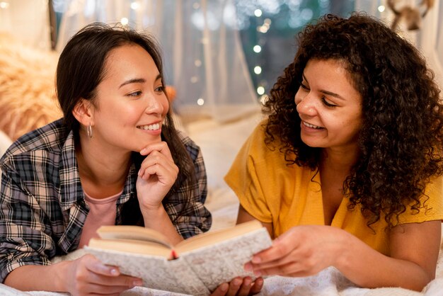 Close-up happy women friends reading