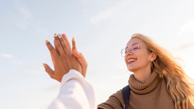 Free photo close-up happy women low angle