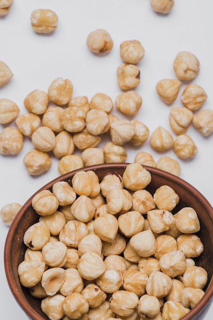 Close-up hazelnuts spilled from bowl