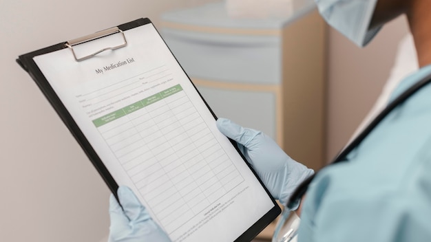 Free photo close up health worker checking medication list