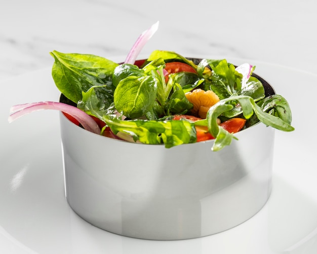 Close-up of healthy salad in metal round form arrangement