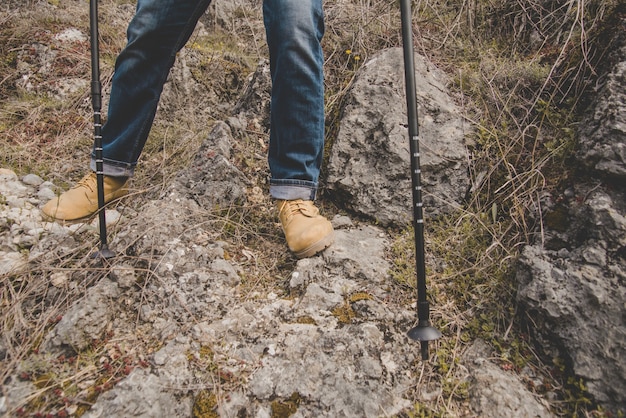 Close-up of hiker with boots and walking sticks