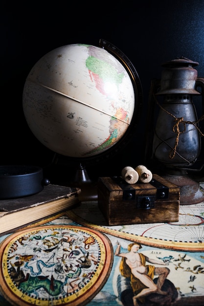 Free photo close-up of historical map with globe and lantern