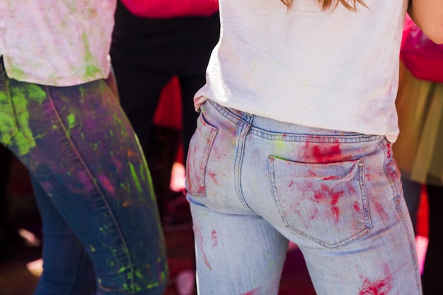 Close-up of holi color powder on women's jean