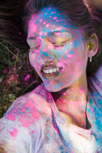 Close-up of holi color on woman's face