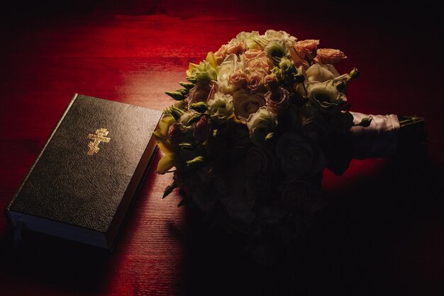 Close up of holy bible with bouquet of flowers on wooden table christian background with copy space