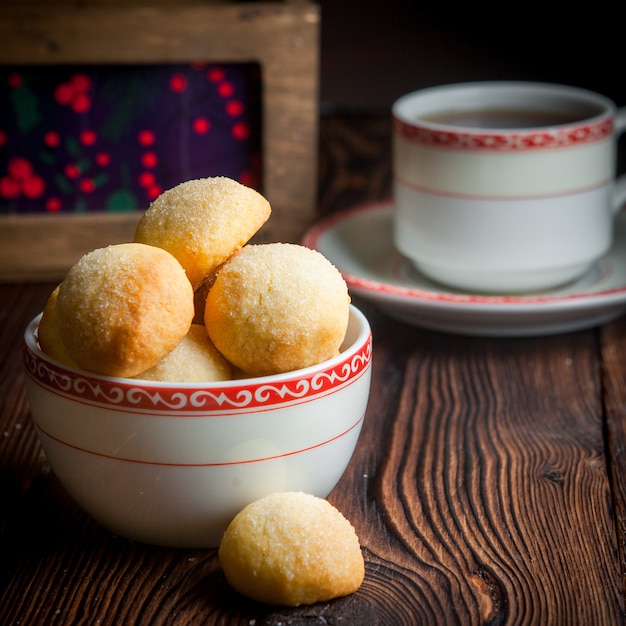 Close-up homemade bake with cup of tea on wooden table