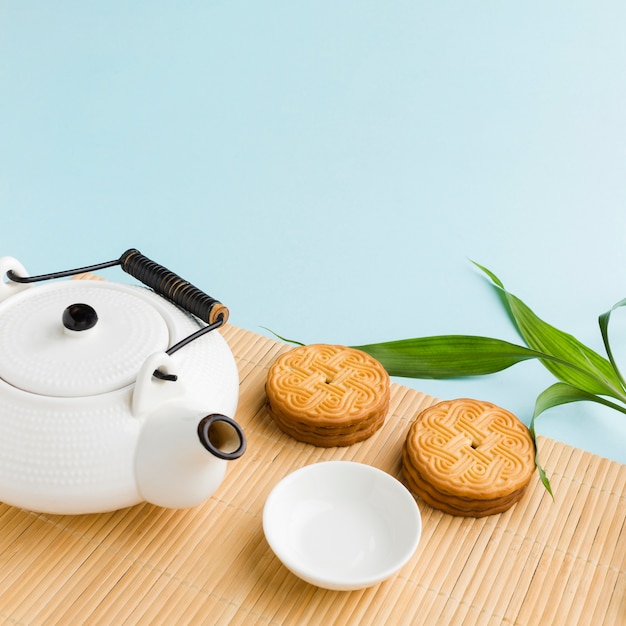 Close-up homemade cookies with teapot on the table