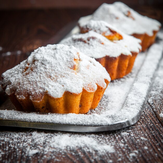 Close-up homemade fruit muffins on wooden table