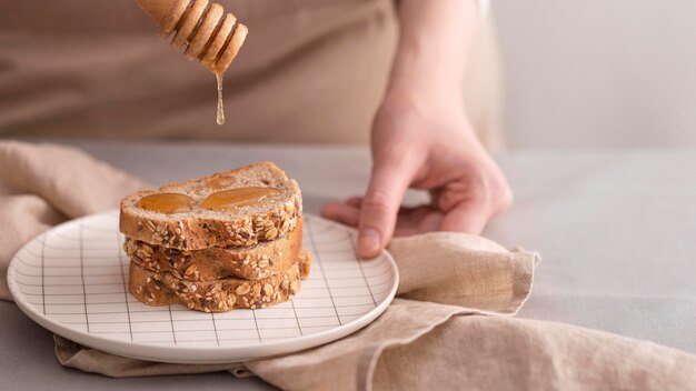 Крупным планом мед на ломтики хлеба