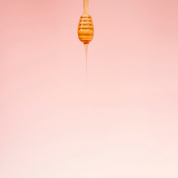 Close-up honey pouring from stick