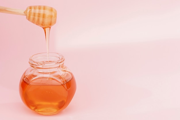 Close-up honey pouring into bowl