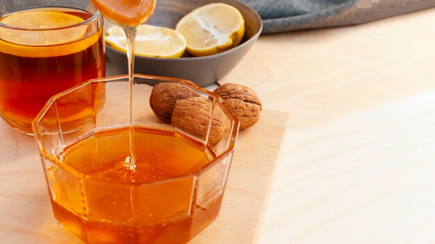 Close-up honey pouring into glass