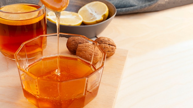 Close-up honey pouring into glass