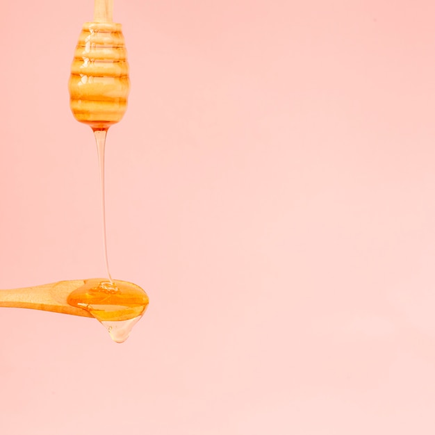 Close-up honey pouring on a spoon