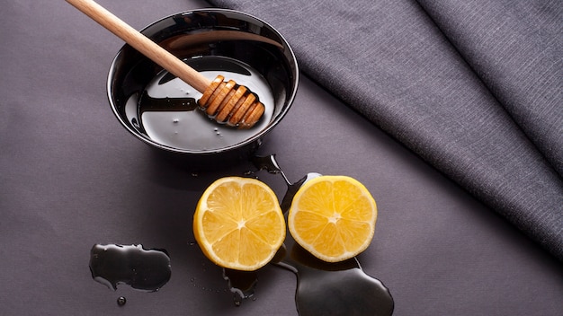 Close-up honey stick and lemon slices