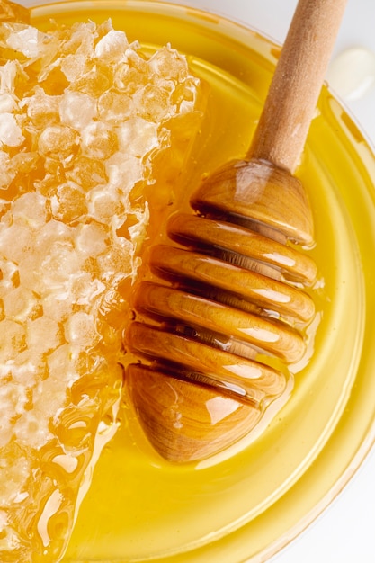 Close up honeycomb with wooden dipper