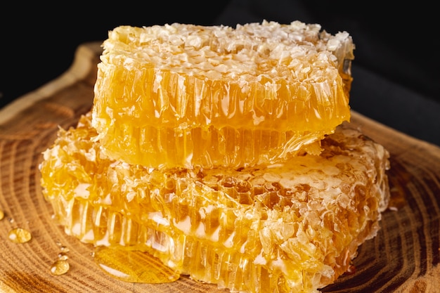 Close up honeycombs on wooden platter