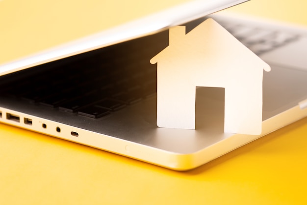 close-up house figure with laptop