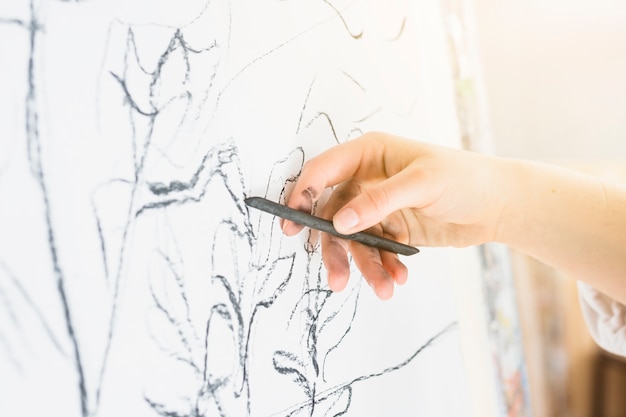 Free photo close-up of human hand drawing with charcoal