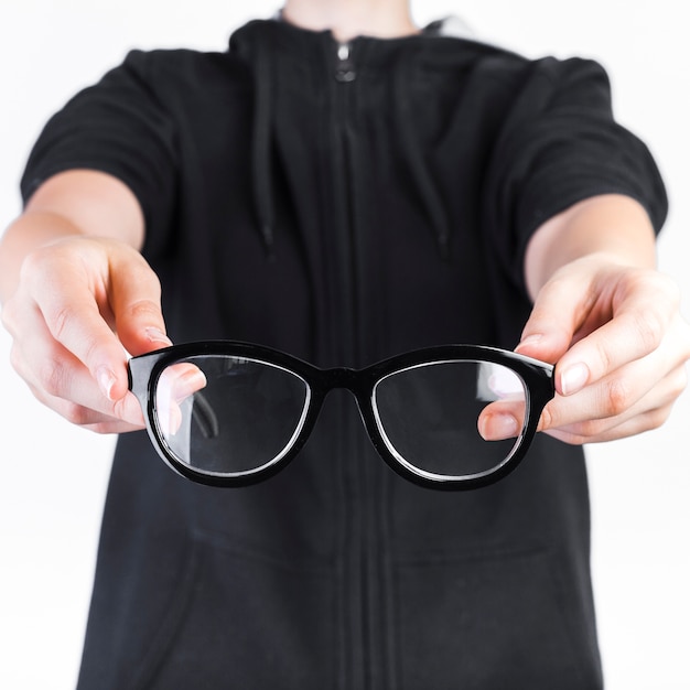 Free photo close-up of a human hand holding spectacles