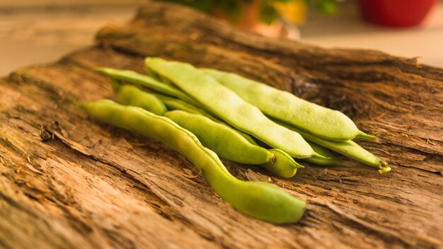 Close-up of hyacinth bean on rough wooden textured backdrop