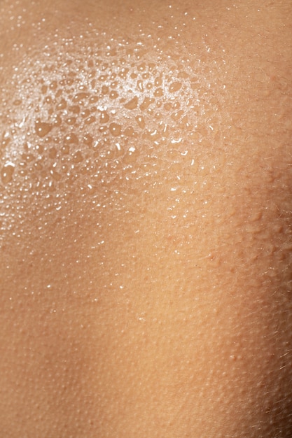 Close up hydrated skin texture with water drops