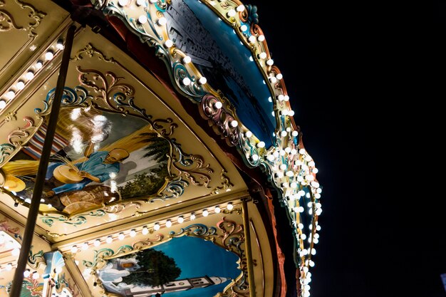 Close-up of an illuminated carousel ride under sky