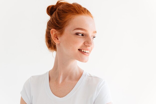 Close up image of beauty ginger woman in t-shirt looking away