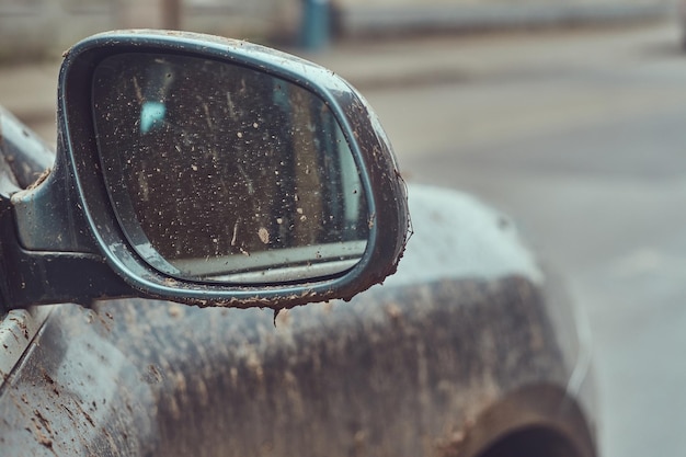 Close-up image of a dirty car after a trip around the countryside