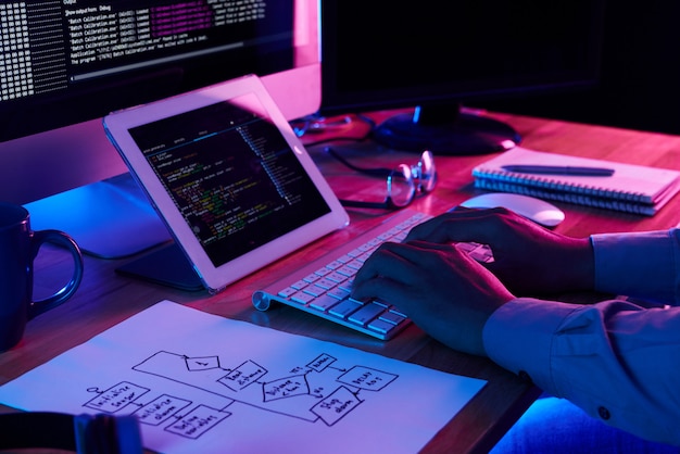 Close-up image of programer working at his desk in office
