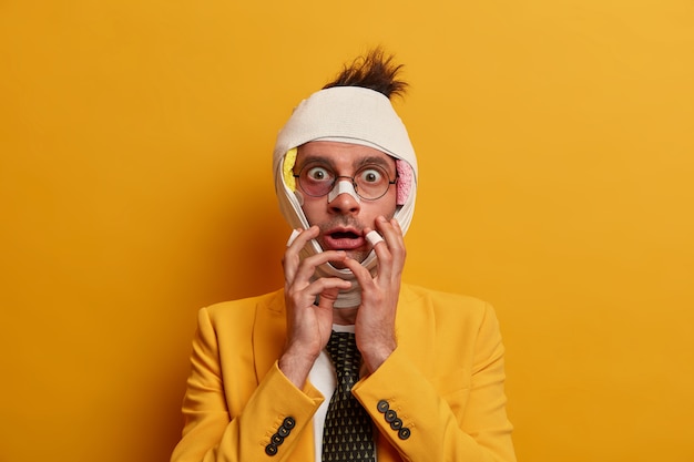 Free photo close up on injured man with dark bruise under eyes and brain concussion, wears bandage