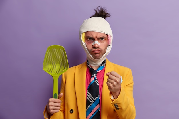 Free photo close up on injured man with dark bruise under eyes and brain concussion, wears bandage