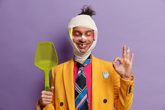 Close up on injured man with dark bruise under eyes and brain concussion, wears bandage