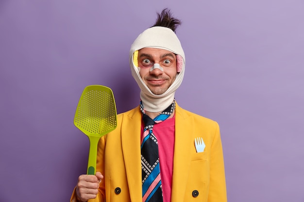 Free photo close up on injured man with dark bruise under eyes and brain concussion, wears bandage