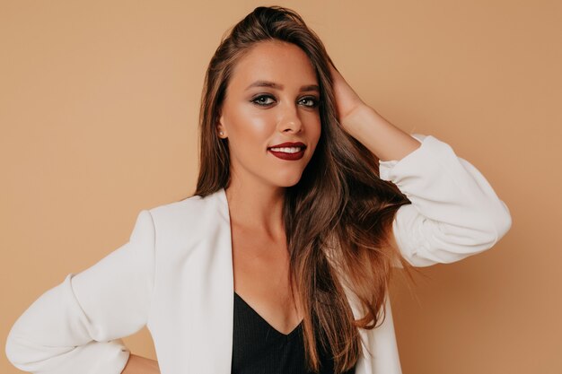 Close up inside portrait of adorable lovely woman with dark lipstick posing in studio