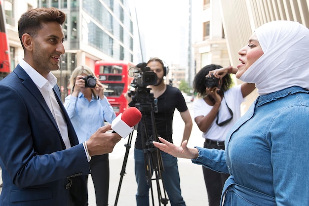 Close up on interviewee with microphone taking statements