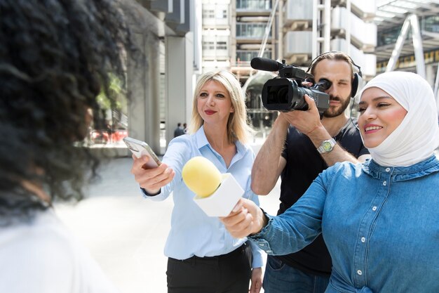 Close up on interviewee with microphone taking statements