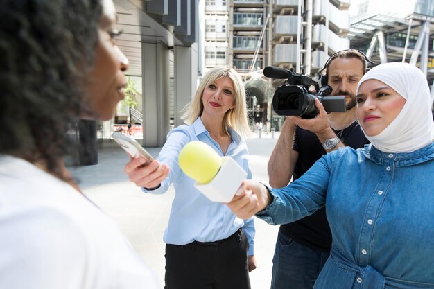 Close up on interviewee with microphone taking statements