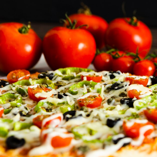 Close-up of italian pizza and tomatoes