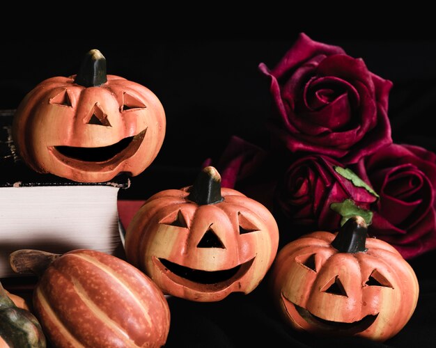Close-up of jack-o'-lanterns and roses