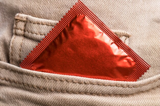 Close-up jeans pocket with wrapped condom 