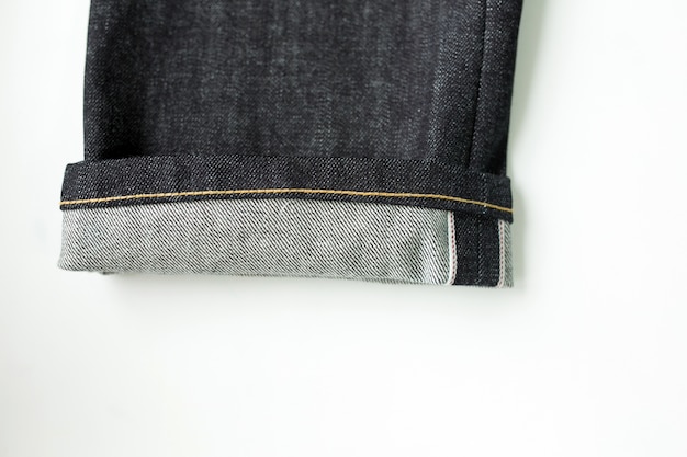 Close-up of jeans with white background