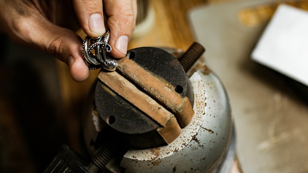 Free photo close-up. the jeweler makes a silver ring. on the island of bali. indonesia