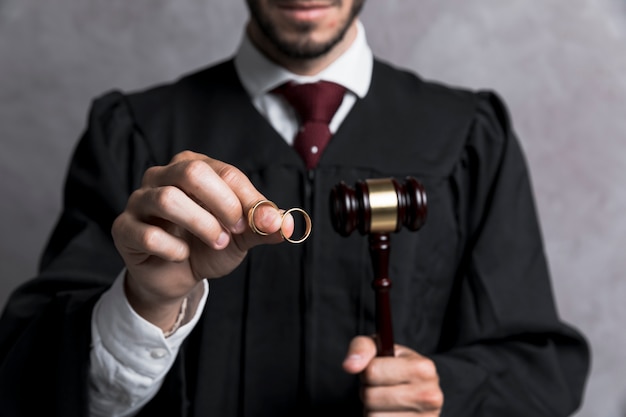 Close-up judge with golden rings and gavel