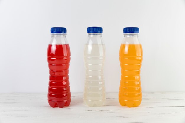 Close up juice bottles on table with white background