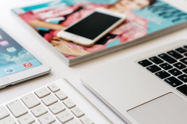 Close-up keyboard next to a laptop