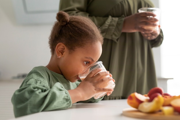 Close up kid drinking smoothie