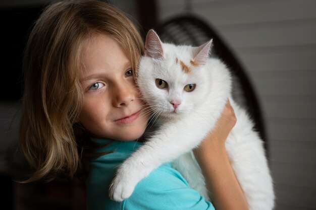 Close up kid holding cat